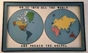 A hand-made world map reading 'Go ye into all the world and preach the gospel'