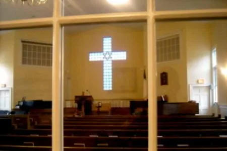 The sanctuary seen through a window, with the glass-block cross on the front wall