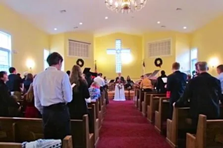 Families standing together during worship in the sanctuary